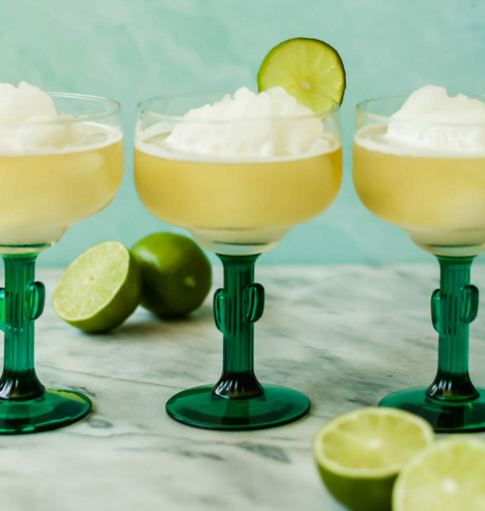 beerita garnished with lime wheels in cocktail glasses