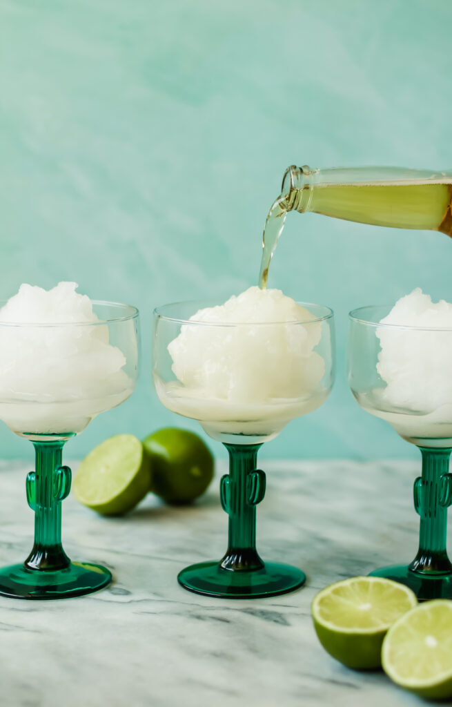 pouring light beer into a frozen beer margarita