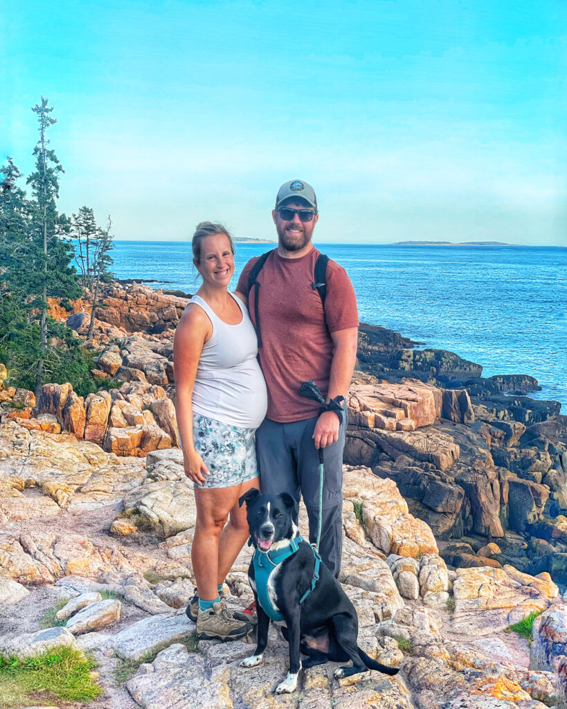 family hiking with dog in acadia national park