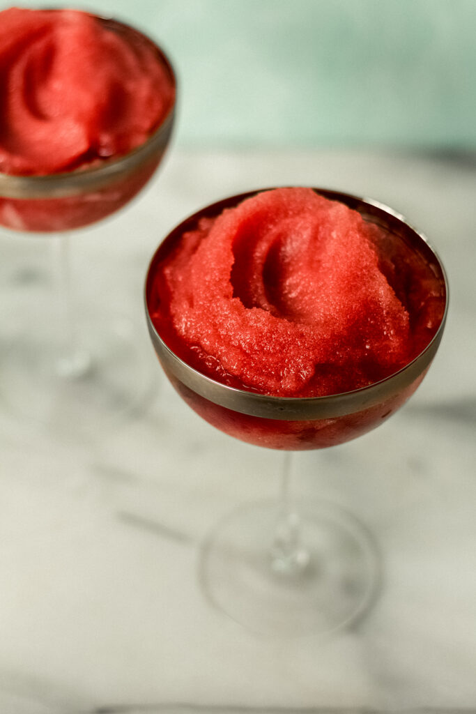 two glasses with red slush cocktails