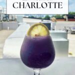 A purple cocktail garnished with a lemon slice sits on a patio table overlooking a cityscape, with text reading Charlotte's best patios and the logo off the eaten path at the bottom.