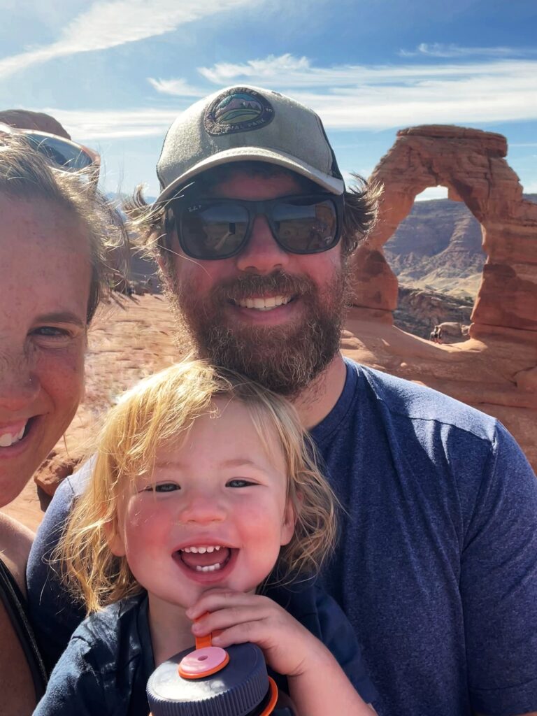 family selfie in front of delicate arch