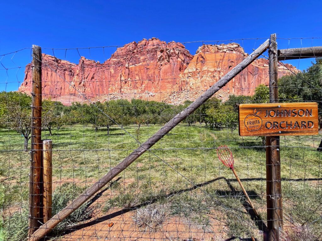 sign and fence of a fruit orchard at capitol reef national park