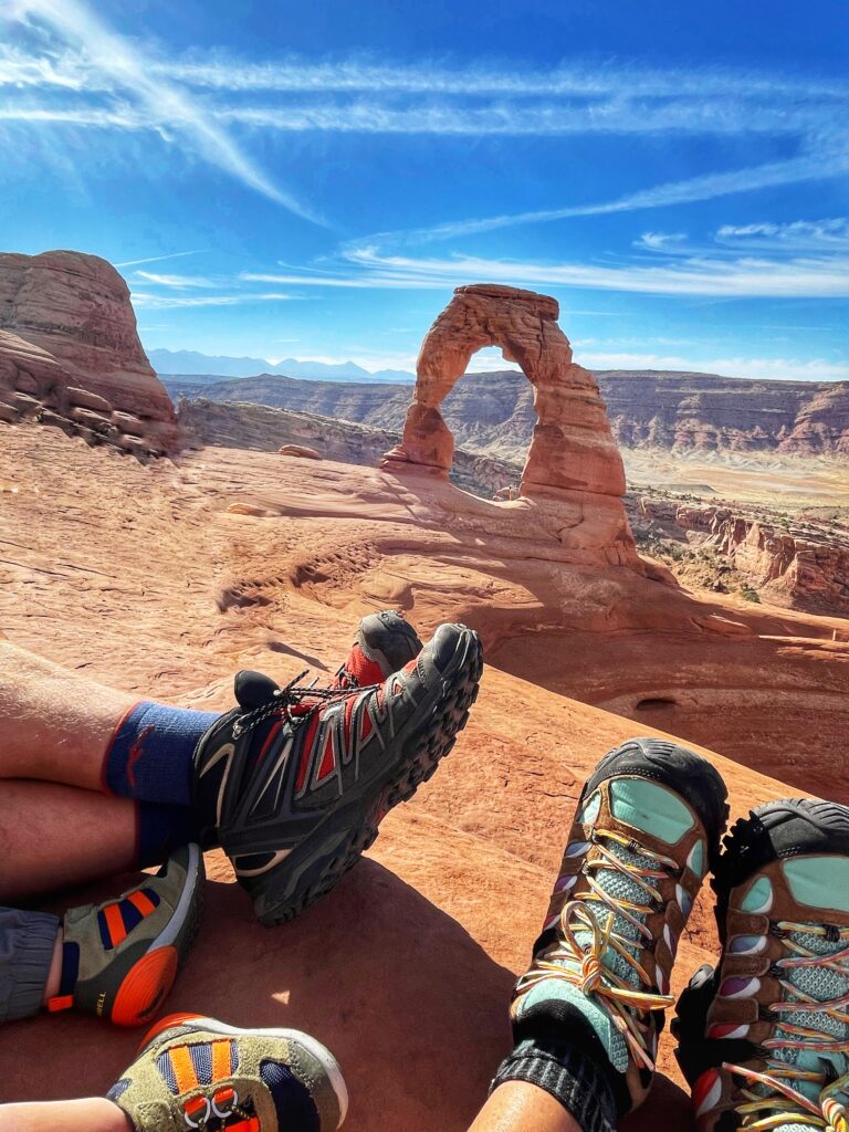 sitting with a view of delicate arch and hiking boots