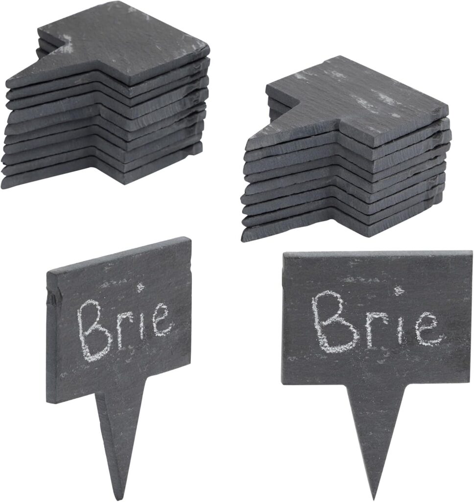 Four stacks of small, rectangular, black slate signs with pointed bases, two of which are labeled Brie in white chalk. The signs are designed to be placed in food items for labeling.