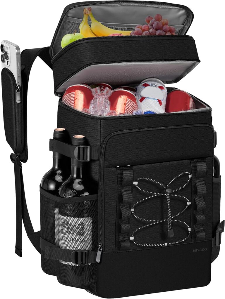 A black backpack cooler with an open top showing bananas, grapes, cans, and ice inside. There are bottles and a mesh pocket with a drink on the side, and a phone in a strap pocket on the shoulder.