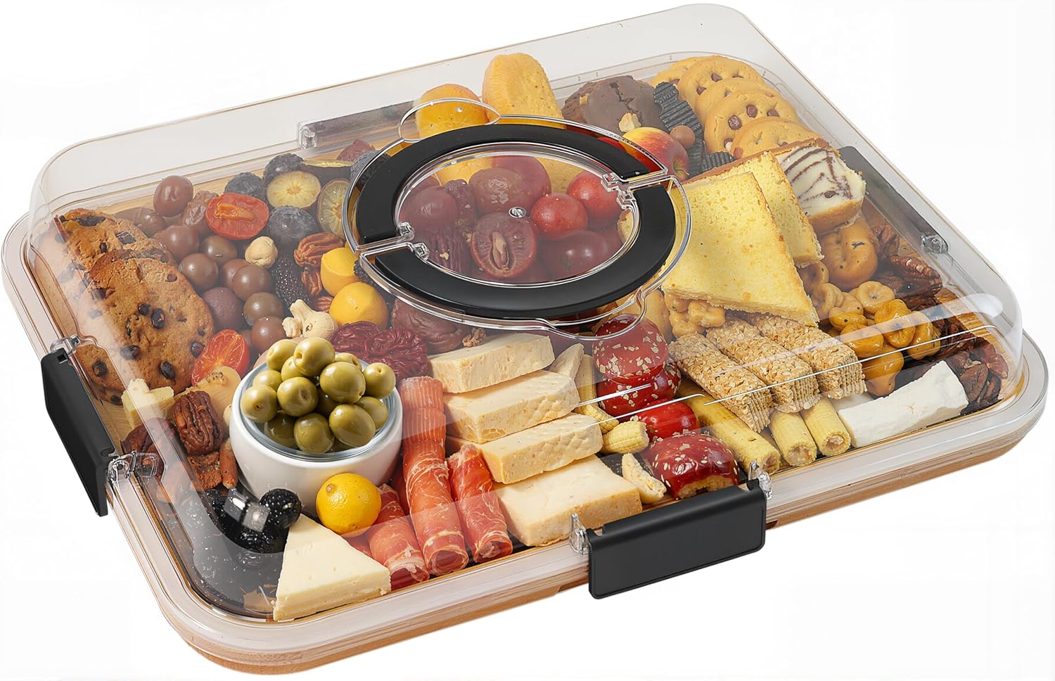 A rectangular tray covered with a clear plastic lid, filled with assorted cheeses, crackers, cured meats, grapes, cherry tomatoes, green olives, cookies, and bread slices arranged neatly for serving.