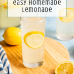A glass of lemonade with a lemon slice, a whole lemon, and a sliced lemon on a wooden board. Behind, more lemonade in pitchers. Text: 3 ingredients easy homemade lemonade..